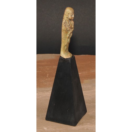 864 - Antiquities - an Ancient Egyptian faience shabti, 9cm long, collector's display stand