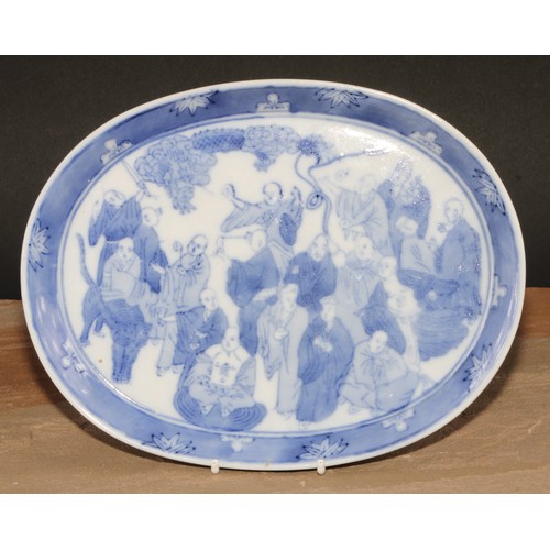 164 - A Chinese oval tray, decorated in tones of underglaze blue with a dense arrangement of figures, 24.5... 