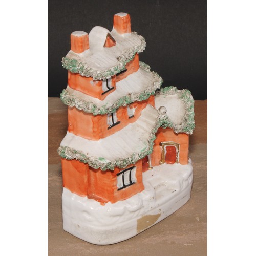 101 - A 19th century Staffordshire pottery novelty money box or bank, modelled as a cottage, 19cm high, c.... 