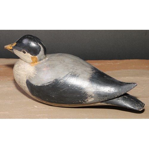 300 - A painted softwood avian decoy, carved as a water fowl, 25cm long