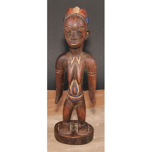 845 - Tribal Art - an African figure, she stands, stylised coiffure, decorated in polychrome pigments, 27c... 