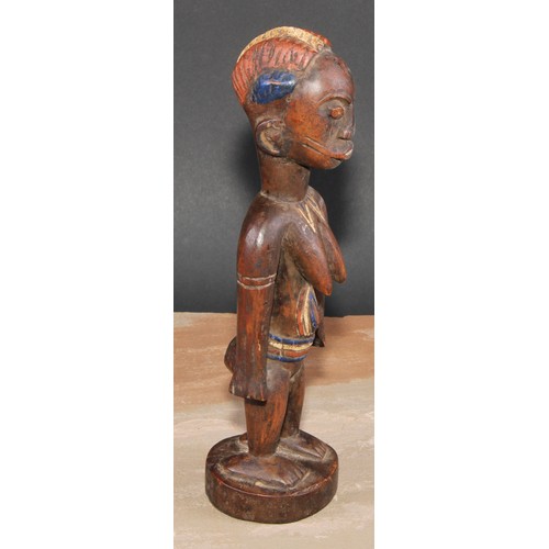 845 - Tribal Art - an African figure, she stands, stylised coiffure, decorated in polychrome pigments, 27c... 