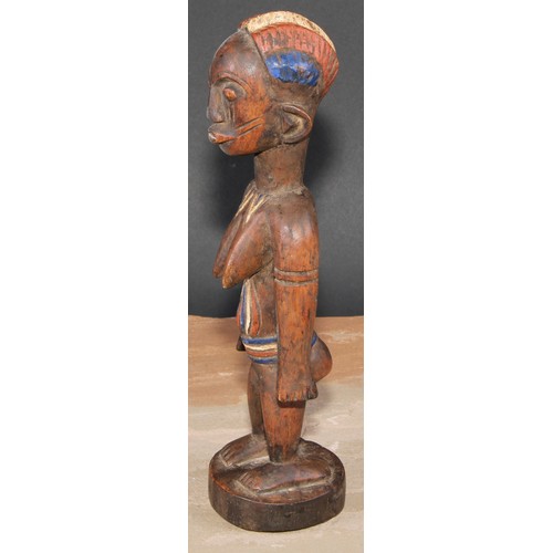 845 - Tribal Art - an African figure, she stands, stylised coiffure, decorated in polychrome pigments, 27c... 