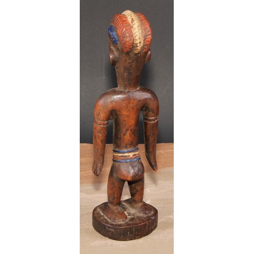 845 - Tribal Art - an African figure, she stands, stylised coiffure, decorated in polychrome pigments, 27c... 