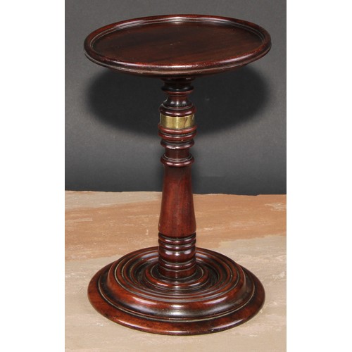 217 - A George III mahogany adjustable table top  candle stand, dished circular plateau, turned pillar and... 