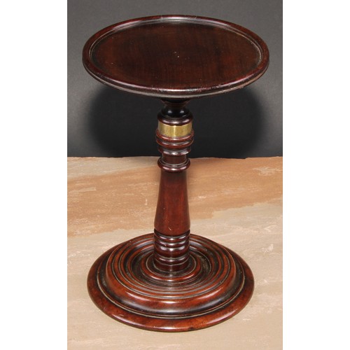 217 - A George III mahogany adjustable table top  candle stand, dished circular plateau, turned pillar and... 