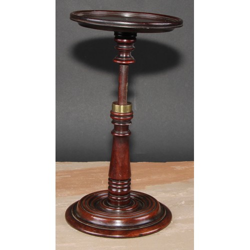 217 - A George III mahogany adjustable table top  candle stand, dished circular plateau, turned pillar and... 