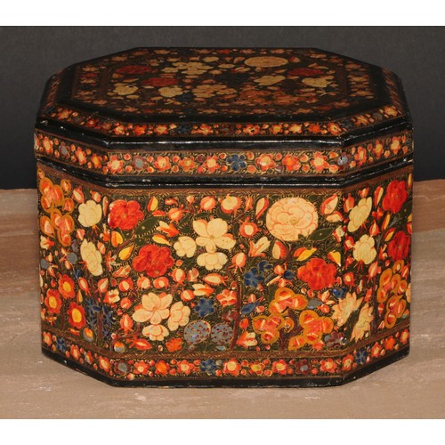 243 - A Kashmiri canted rectangular box and cover, decorated overall in polychrome with a dense arrangemen... 