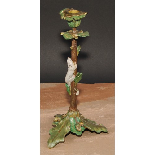 318 - A pair of Austrian cold painted bronze novelty candlesticks, each cast with a squirrel climbing amon... 