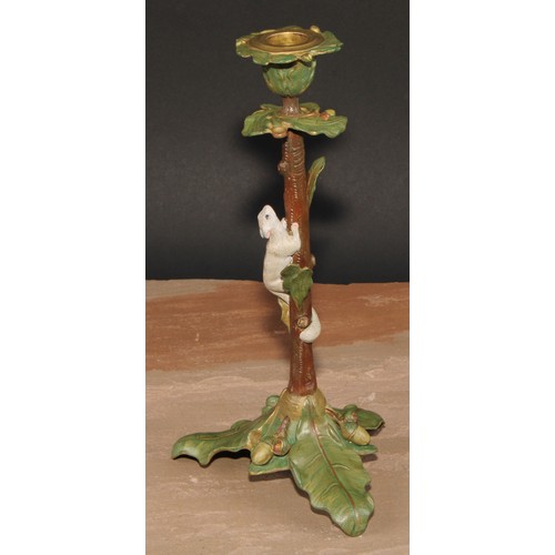 318 - A pair of Austrian cold painted bronze novelty candlesticks, each cast with a squirrel climbing amon... 