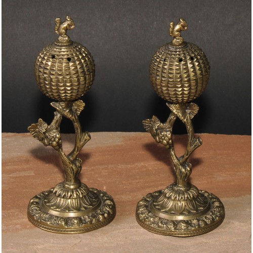 347 - A pair of post-Regency gilt bronze cassolettes, each crested by a squirrel, fruiting vine supports, ... 