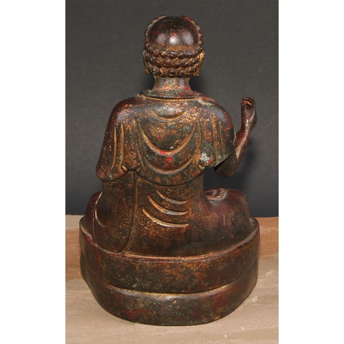 524 - Chinese School, a bronze Buuddha, seated in meditation, traces of gilding, 24cm high