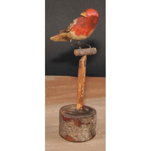 556 - Folk Art - a soft wood avian model, carved and painted as a bird on a perch, 21cm high