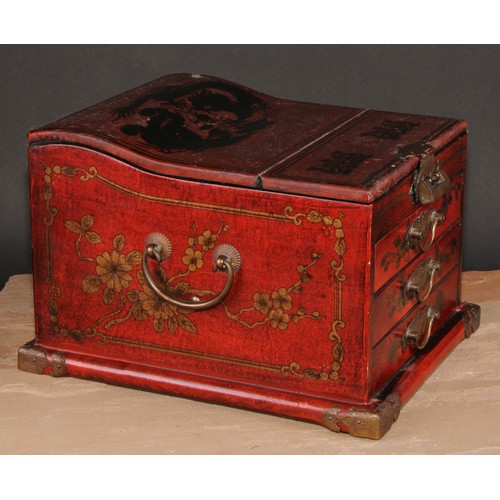 175 - A Chinese red lacquer table top vanity chest, hinged cover enclosing a folding mirror, above three d... 