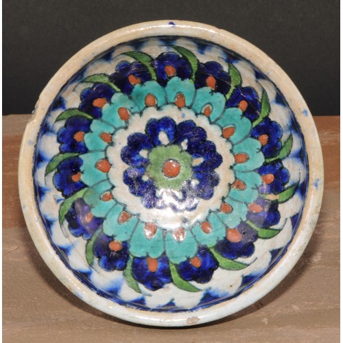 285 - A Middle Eastern tin glazed bowl, decorated in the Iznik palette, 13cm diam, D & S Howlett Collectio... 