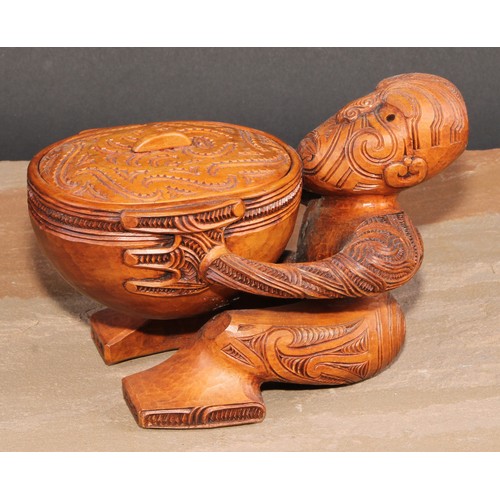 823 - A Maori figural pouaka box, carved overall with puhoro, 18.5cm wide, New Zealand