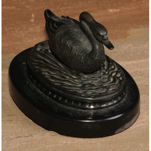 43 - A 19th century dark-patinated bronze, of a swan on the water, oval Noir Belge base, 11cm wide