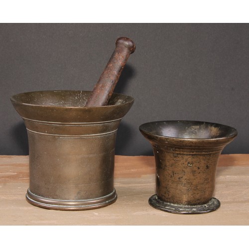 416 - An 18th century bronze pestle and mortar, flared rim, 12.5cm cm high, c.1760; another, smaller (2)