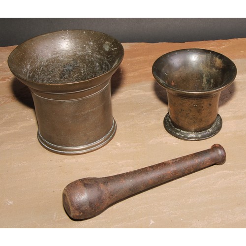 416 - An 18th century bronze pestle and mortar, flared rim, 12.5cm cm high, c.1760; another, smaller (2)