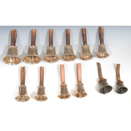 756 - A set of ten brass hand bells, by The Whitechapel Bell Foundry, the G 21cm to top of leather strap, ... 