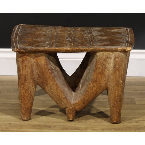 835 - Tribal Art - a Nupe stool, the rectangular top carved with geometric motifs, 30cm high, 48cm wide, C... 