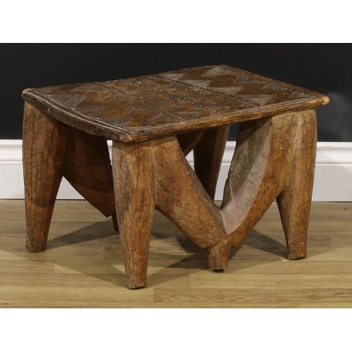 835 - Tribal Art - a Nupe stool, the rectangular top carved with geometric motifs, 30cm high, 48cm wide, C... 