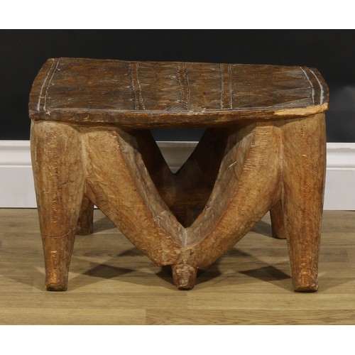 835 - Tribal Art - a Nupe stool, the rectangular top carved with geometric motifs, 30cm high, 48cm wide, C... 