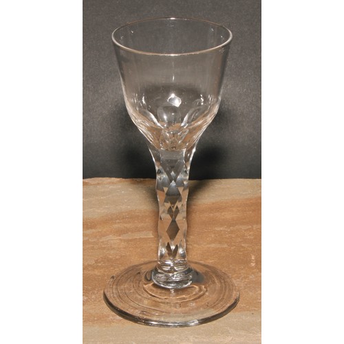 418 - An 18th century trumpet shaped wine glass, drawn stem with tear inclusion, 17cm high; a coloured twi... 