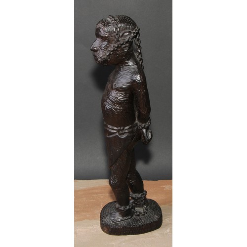 649 - Slavery - a West African tribal hardwood carving, of a slave in chains, 39cm high