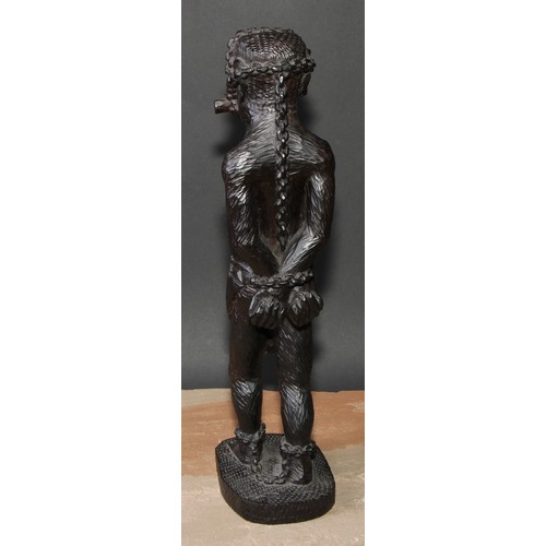 649 - Slavery - a West African tribal hardwood carving, of a slave in chains, 39cm high