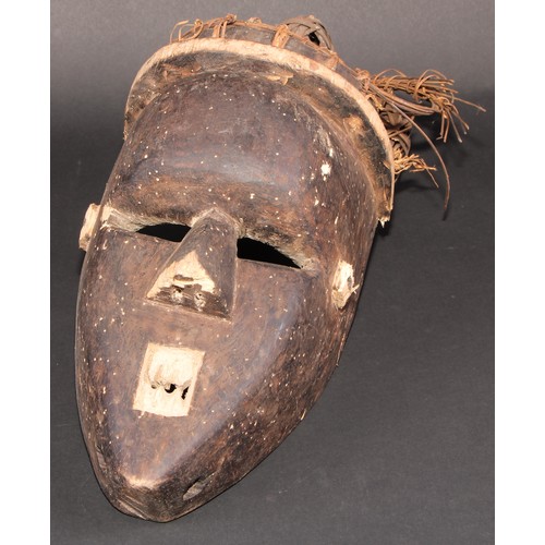 839 - Tribal Art - a Yoruba  helmet mask, decorated in blue and white pigments, Nigeria; another; etc (3)