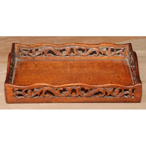 72 - A 19th century mahogany letter tray, the shaped gallery pierced and carved with scrolling flowering ... 