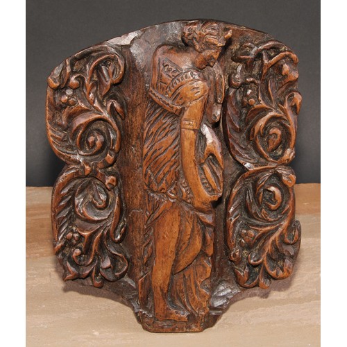 299 - A North European walnut panel, carved in relief with Diana, flanked by scrolling foliage, 27.5cm x 2... 