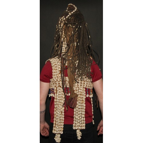 822 - A Dogon girl's helmet mask and vest, stocked with cowrie shells and 'plaited hair' applied with bell... 