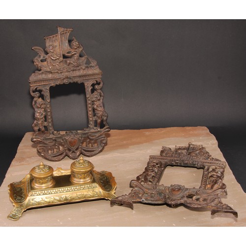 351 - A pair of Victorian cast iron photograph frames, each crested by putti rowing a boat, 37cm high, Rd.... 