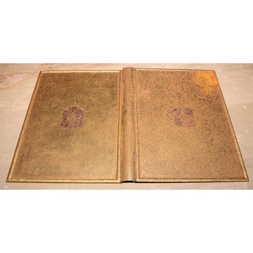 50 - A 19th century gilt damascened steel armorial book cover, centred by a heraldic crest, on a ground o... 