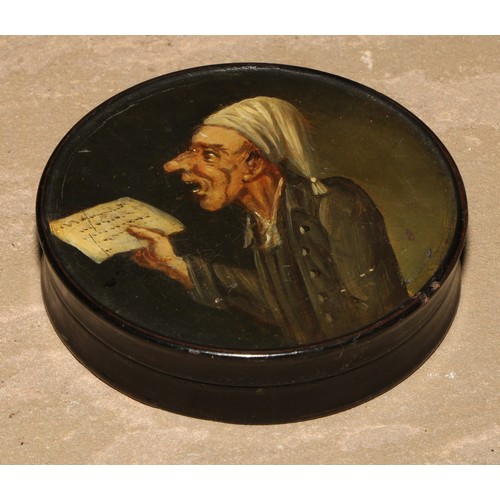 86 - A 19th century papier mache circular snuff box, the cover painted with a ban singing from sheet musi... 