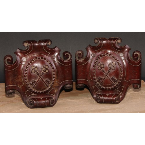 583 - Heraldry - a pair of 19th century mahogany armorial cartouches, carved in relief with crossed keys, ... 