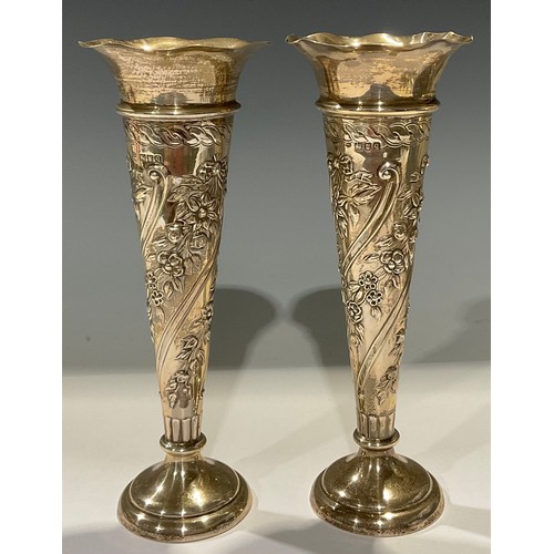 584 - A pair of George V silver trumpet shaped posy vases, embossed with floral garlands, 21cm, London 191... 