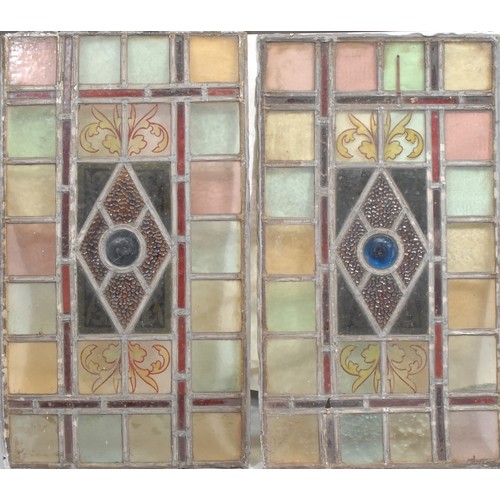 317 - A pair of Arts & Crafts period leaded stained glass rectangular panels, each with central bullseye p... 