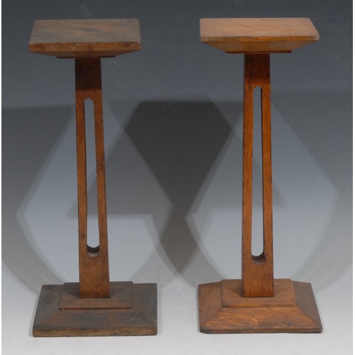 1031 - Haberdashery - a near pair of early 20th century oak shop display stands, square plateaux, square ba... 