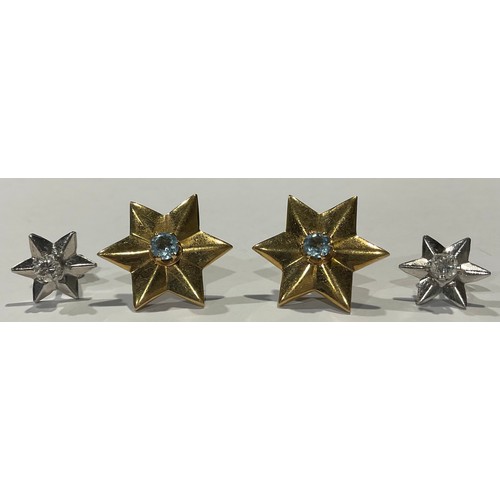 613 - A pair of 18ct gold star shaped earrings, each set with an aquamarine stone, 7g; a pair of unmarked ... 