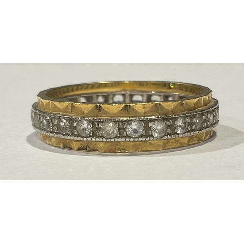 618 - An 18ct white and yellow gold eternity ring, set with diamond chips, size O/P, 4.7g