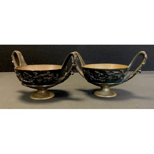 7 - A pair of bronzed coloured metal twin handled censers, cast in relief with trailing vines and grapes... 
