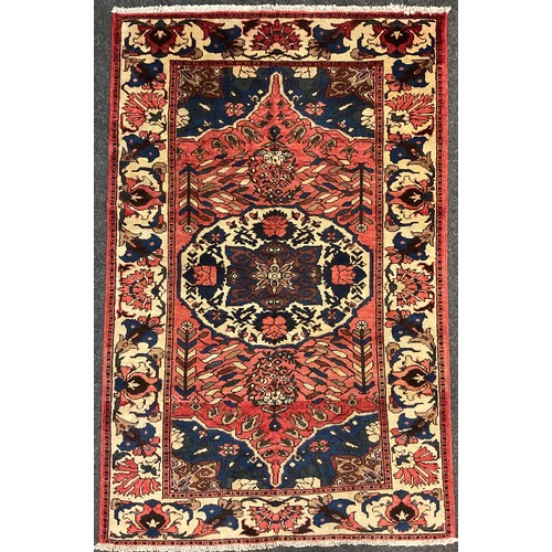 54 - A central Persian Bakhtiar rug / carpet, hand-knotted in muted tones of red, blue, and cream, 209cm ... 