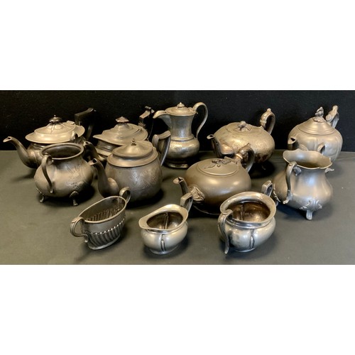 82 - A 19th century pewter three piece tea set,  other teapot, Arts & Crafts water jug,  cream jug Britan... 