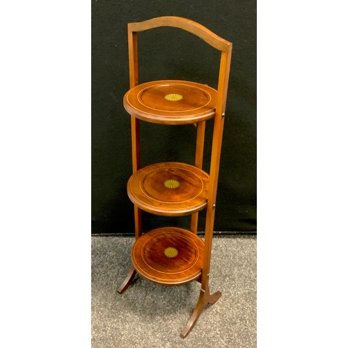 116 - An Edwardian mahogany folding cake stand, decorated with batwing paterae, c.1910