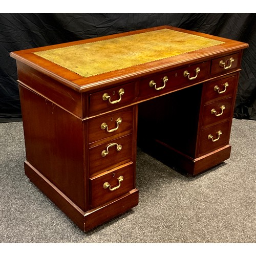 119 - A early 20th century mahogany pedestal table; faux leather top, three drawers to frieze, three drawe... 