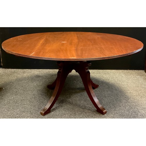 175 - A large 20th century mahogany centre table, reeded rim, four sabre leg pedestal base, scroll knees, ... 