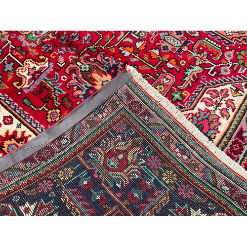 183 - A North West Persian Heriz carpet, hand-knotted with a central diamond-form medallion, within a fiel... 